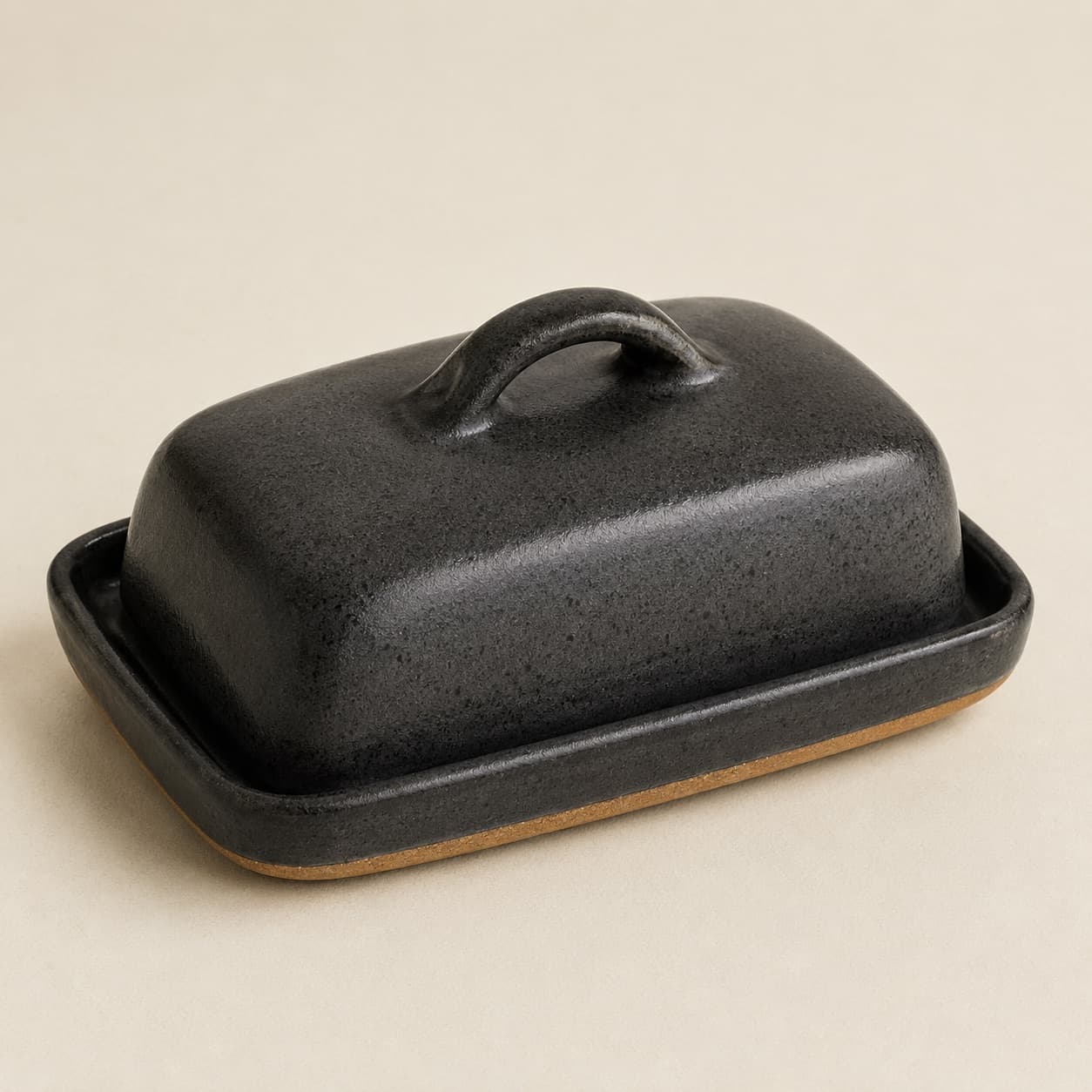 Butter Dish — charcoal glazed stoneware with an unglazed clay foot ring.