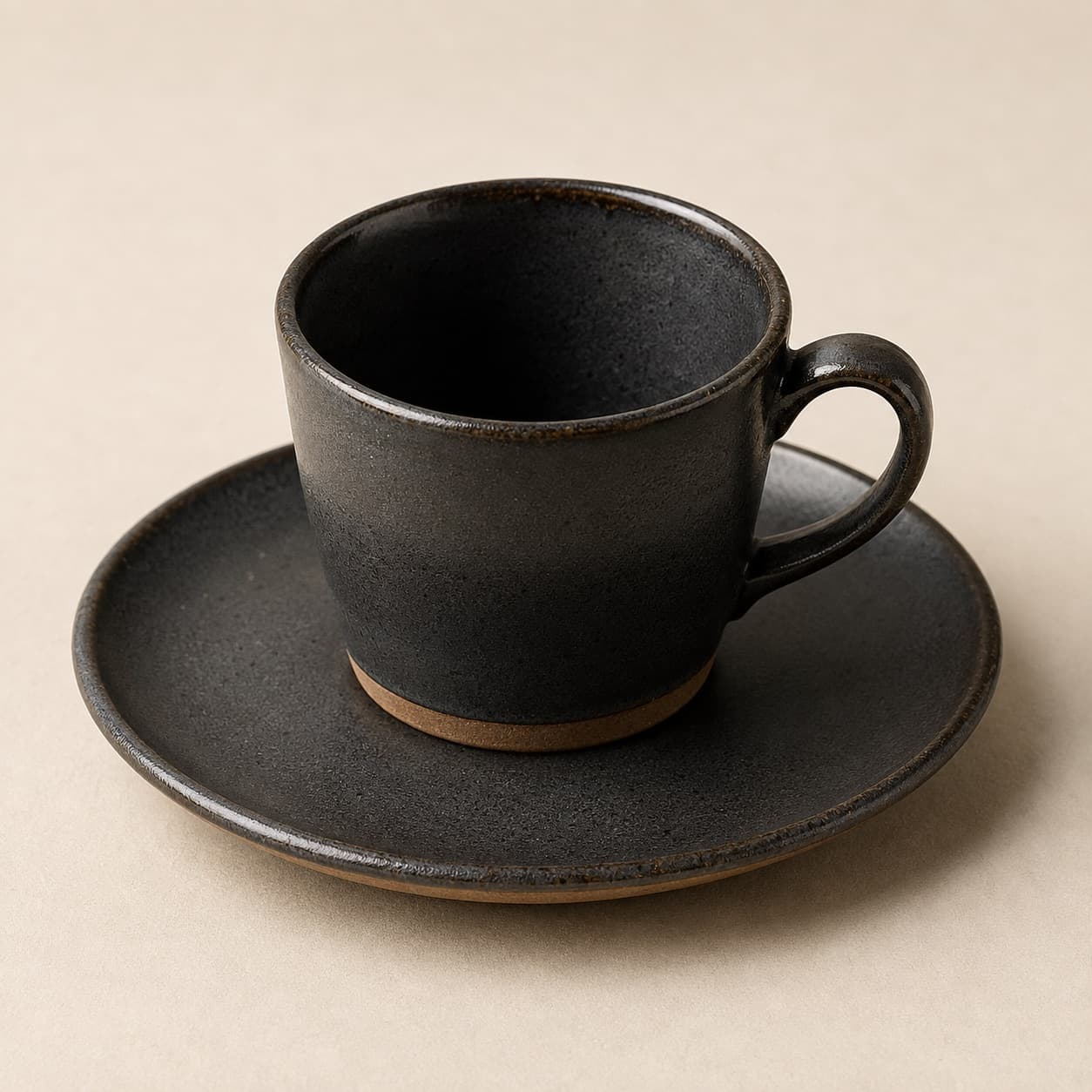 Cortado Cup 150 ml + Saucer — charcoal glazed stoneware with an unglazed clay foot ring.