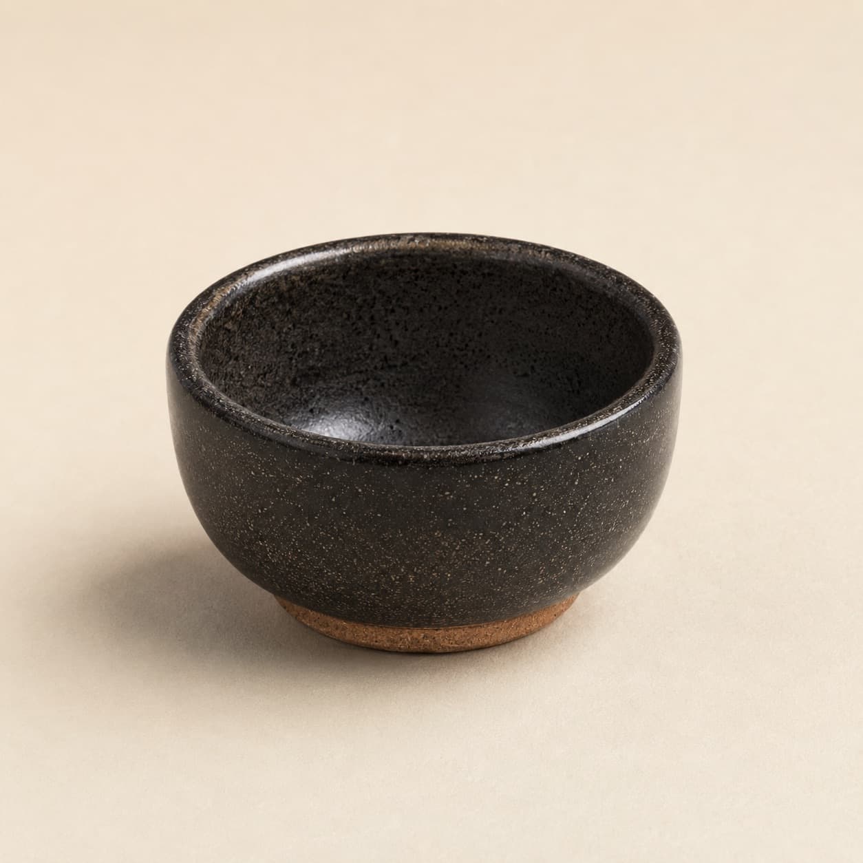 Dip Bowl Ø8 — charcoal glazed stoneware with an unglazed clay foot ring.