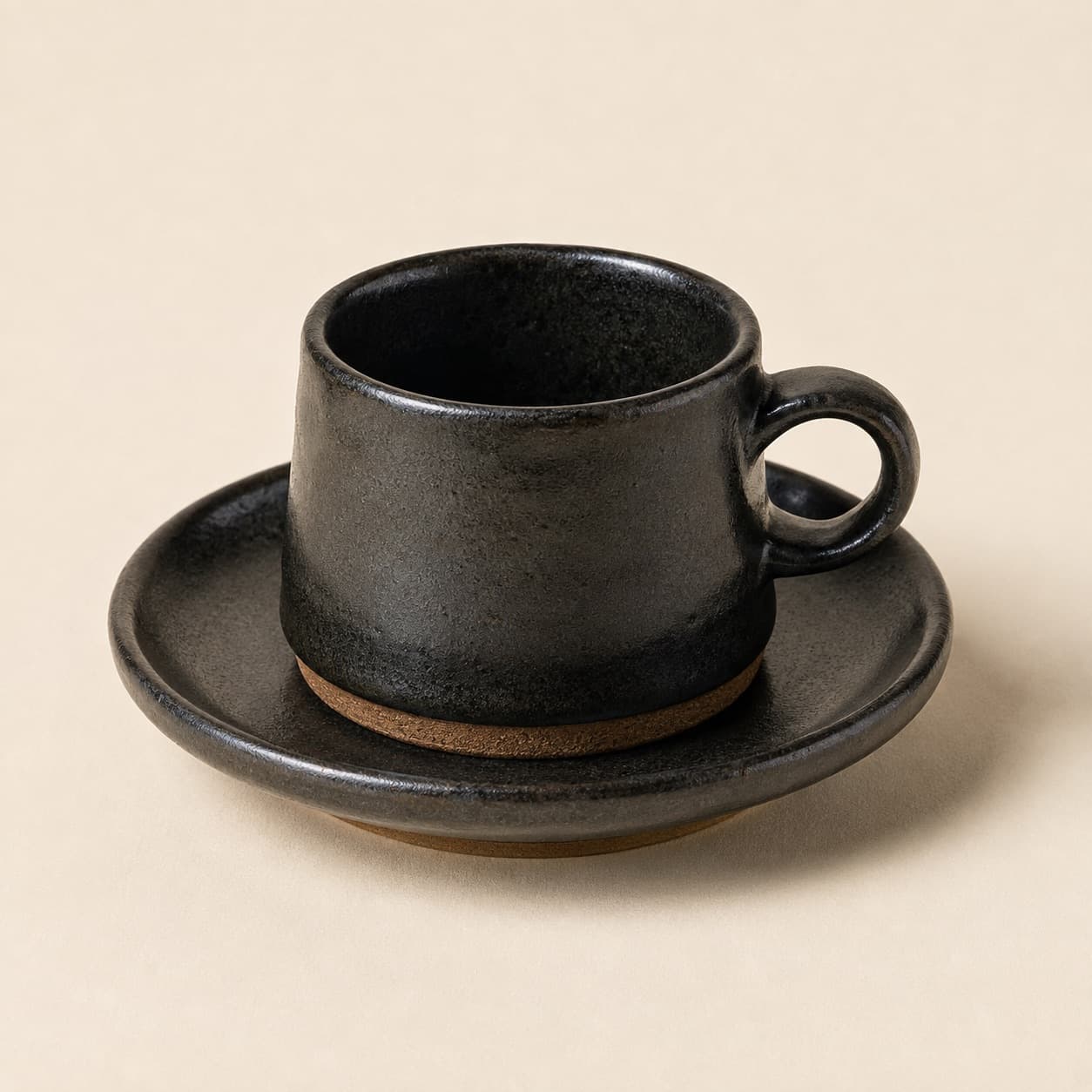 Espresso Cup 80 ml + Saucer — charcoal glazed stoneware with an unglazed clay foot ring.