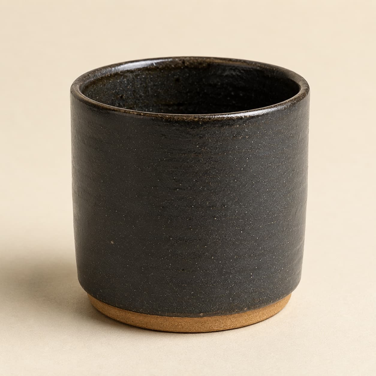 Flat White Cup 200 ml — charcoal glazed stoneware with an unglazed clay foot ring.