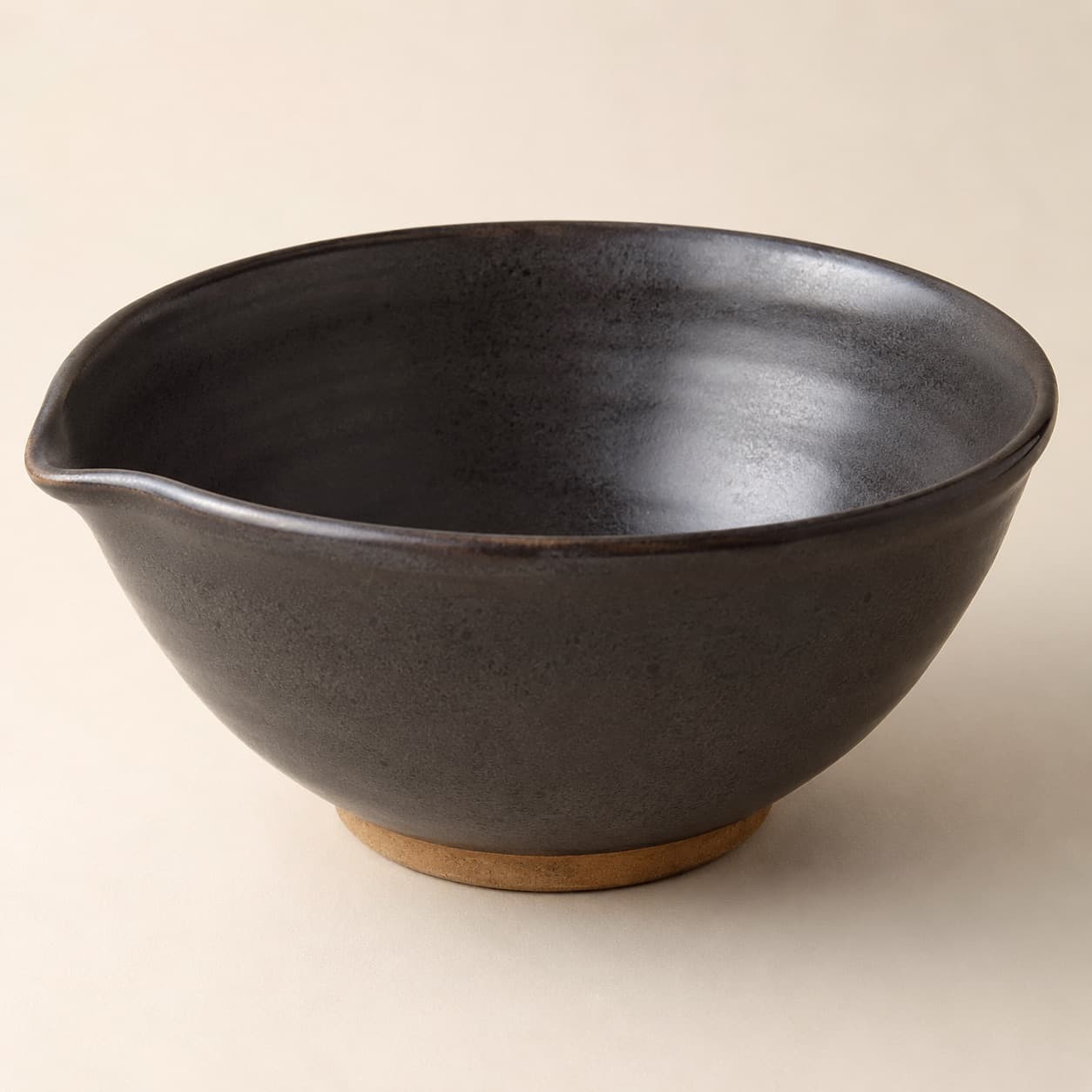 Mixing Bowl Ø26 — charcoal glazed stoneware with an unglazed clay foot ring.