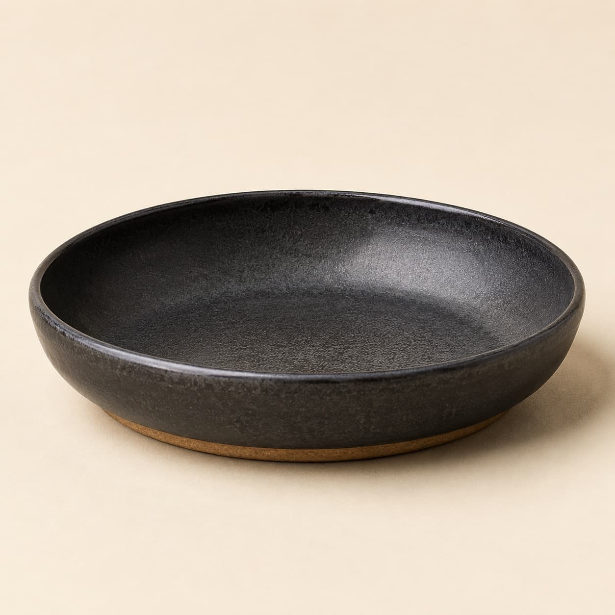 Pasta Bowl Ø22 — charcoal glazed stoneware with an unglazed clay foot ring.