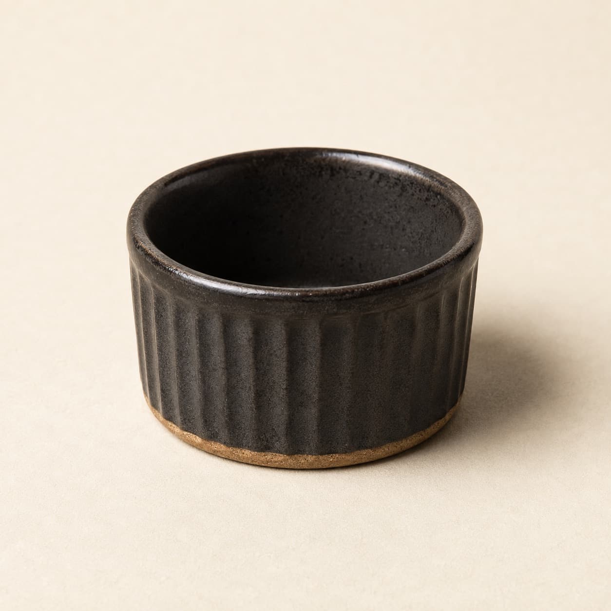 Ramekin 120 ml — charcoal glazed stoneware with an unglazed clay foot ring.