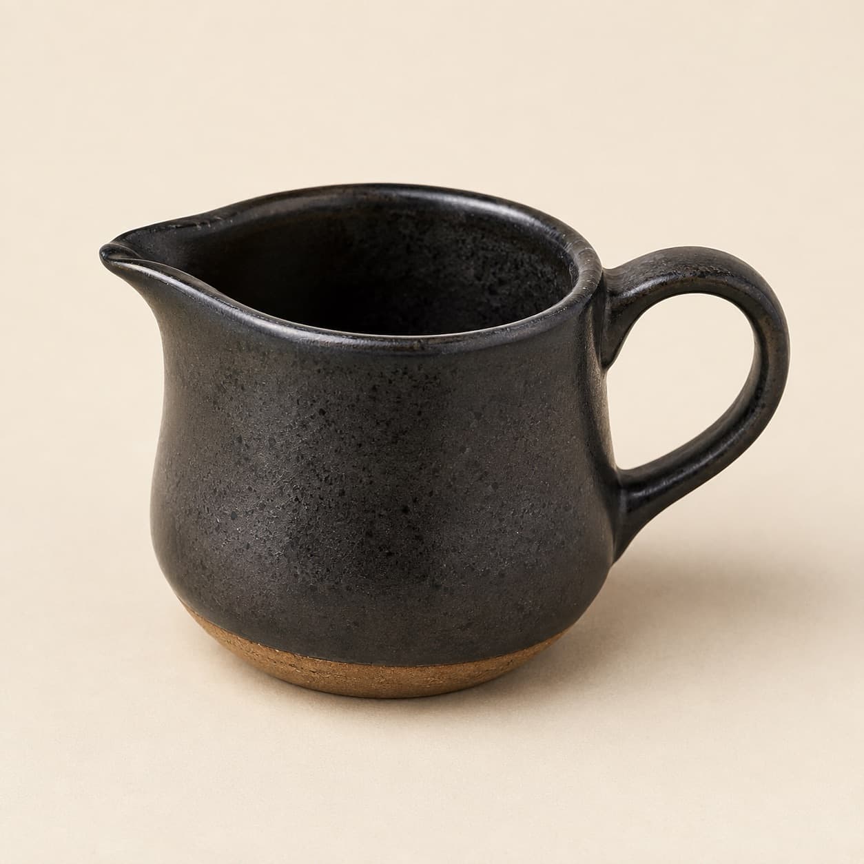 Sauce Jug 250 ml — charcoal glazed stoneware with an unglazed clay foot ring.